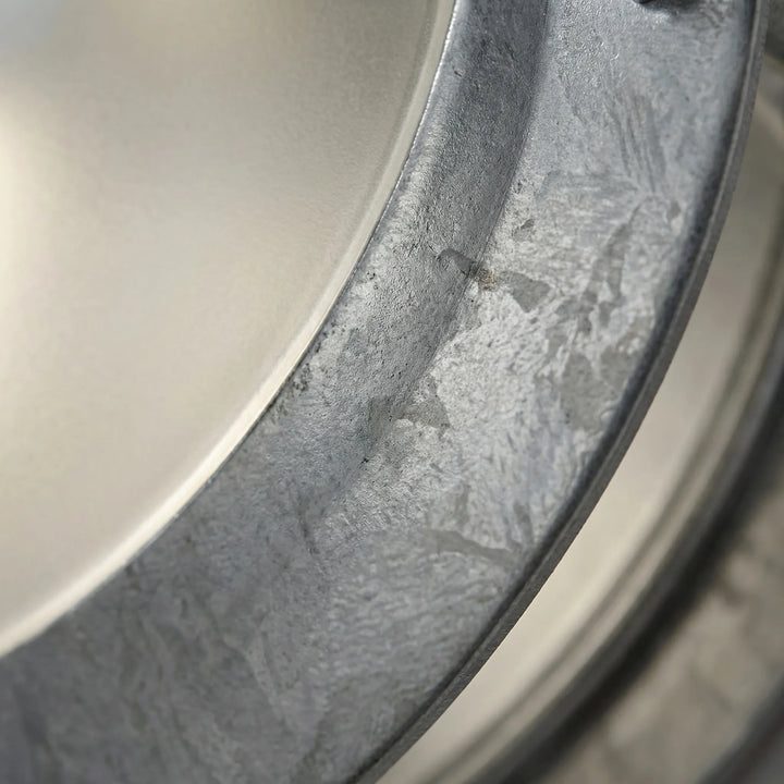 Durable round galvanized steel wall lamp. Weatherproof exterior light for modern outdoor spaces.