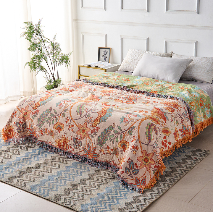 Woven cotton floral blanket in a rustic boho style, great for cozy living room decor.