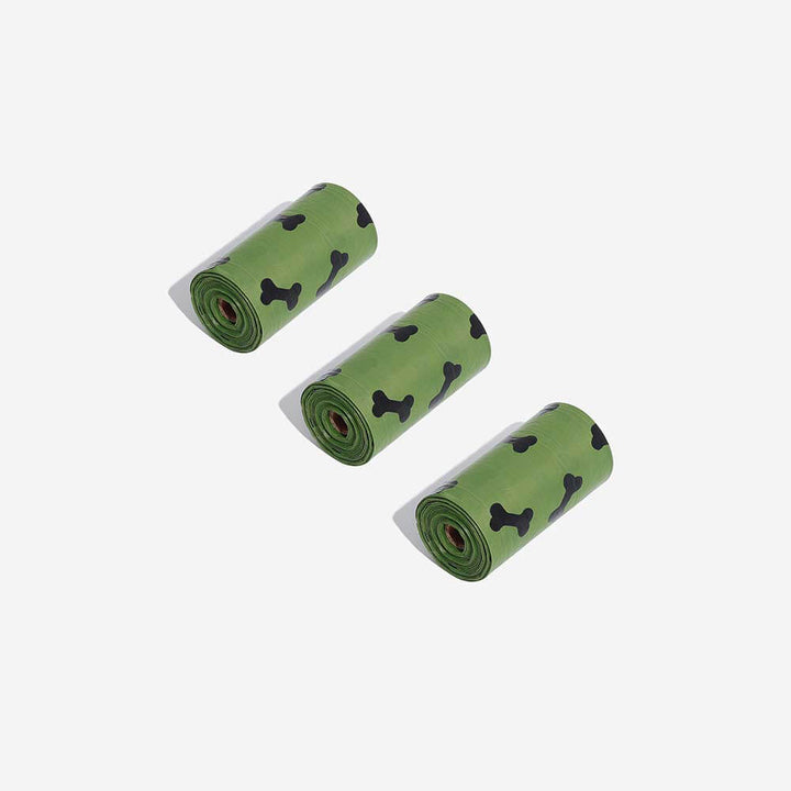 Multiple rolls of scented biodegradable dog waste bags in various colors, bulk pet essentials