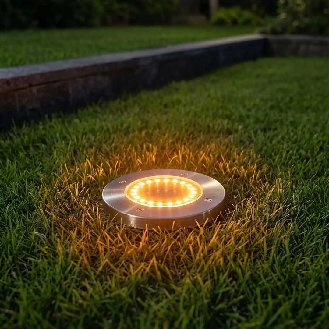 Set of 8 outdoor solar disk lights for garden pathways. Waterproof LED ground lights provide warm white landscape lighting.