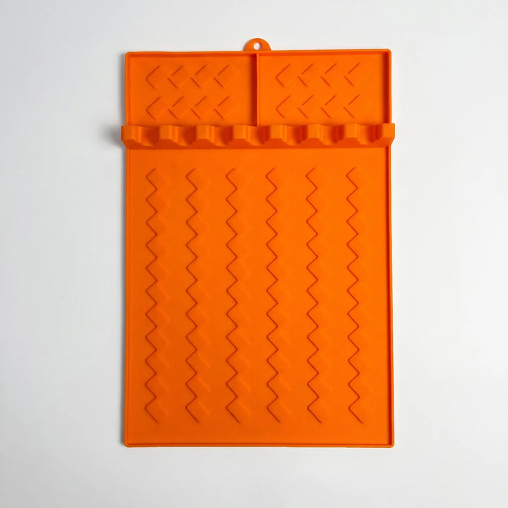 Non-slip silicone grill utensil rest, perfect for holding tongs, spatulas & brushes during BBQ cooking.