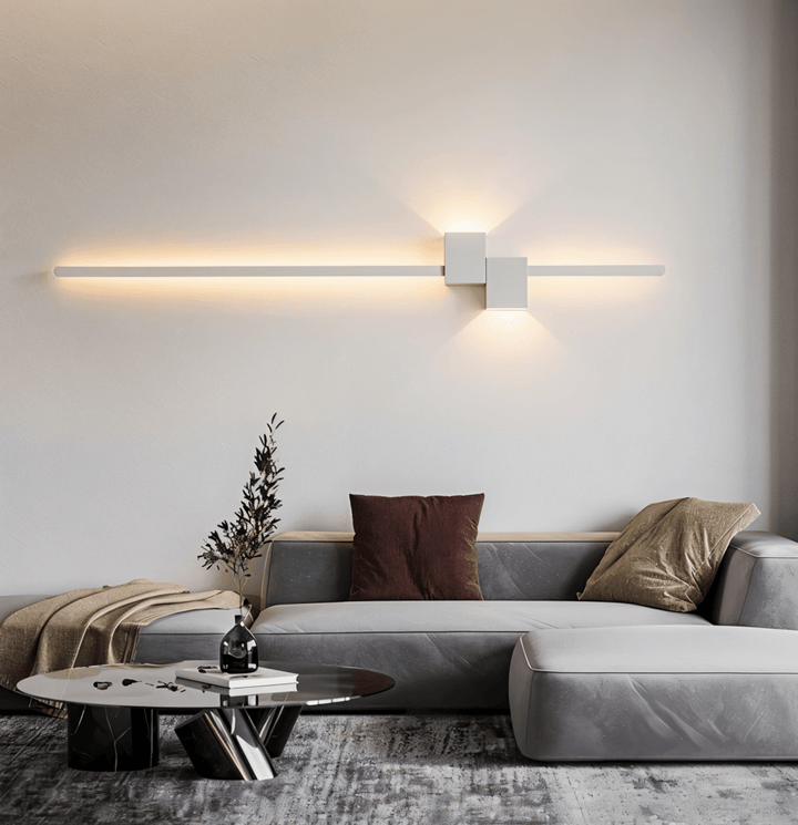 Minimalist LED wall light providing soft ambient bedroom lighting, contemporary sleek fixture.
