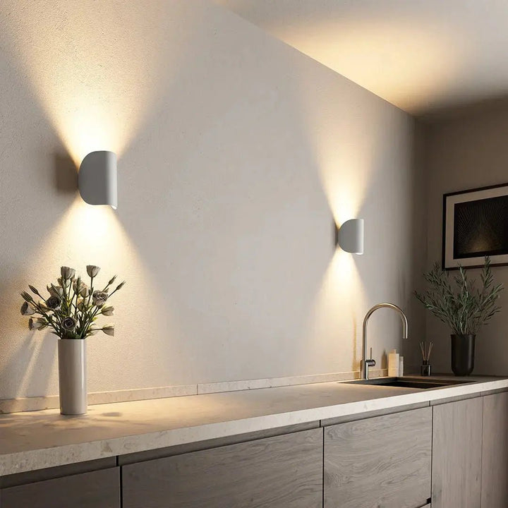 Modern LED wall sconce for bright, energy-efficient interior illumination. Sleek design for bedrooms & living rooms.