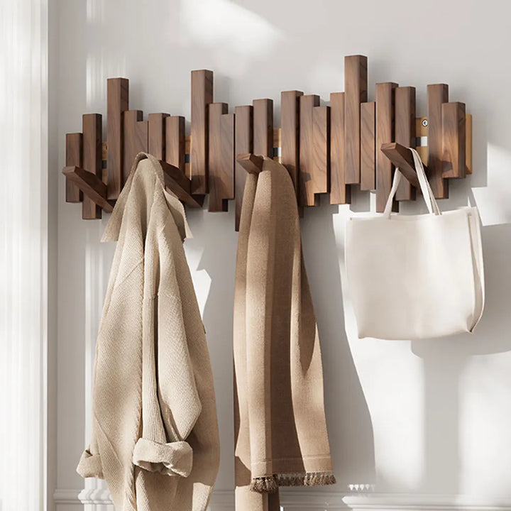 Sleek natural wood folding wall hanger, ideal for entryway organization and space-saving coat storage.