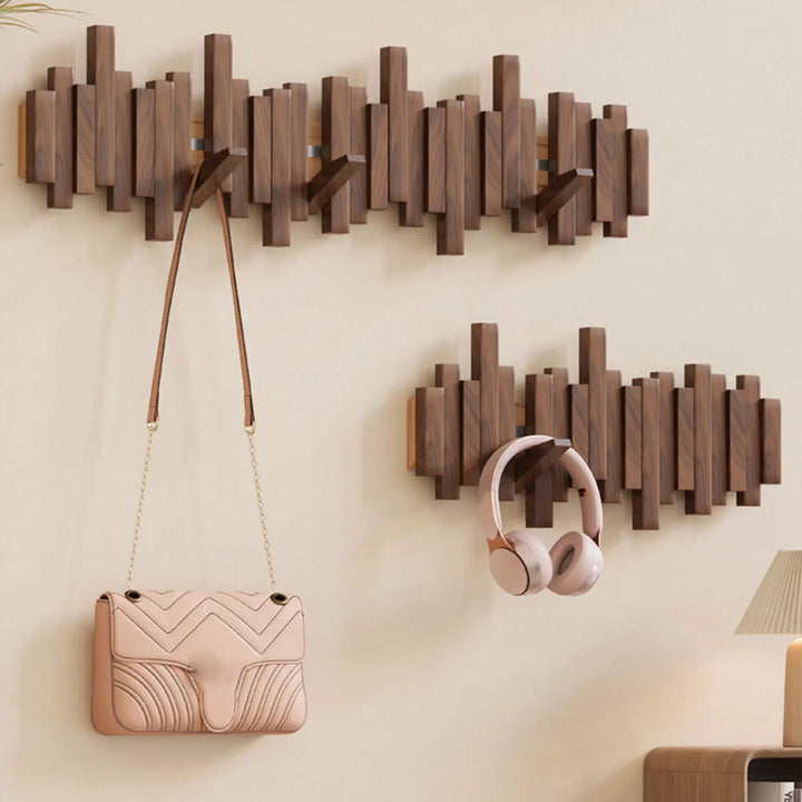 Wall-mounted natural wood folding hooks. A minimalist and space-saving entryway organizer and home decor.