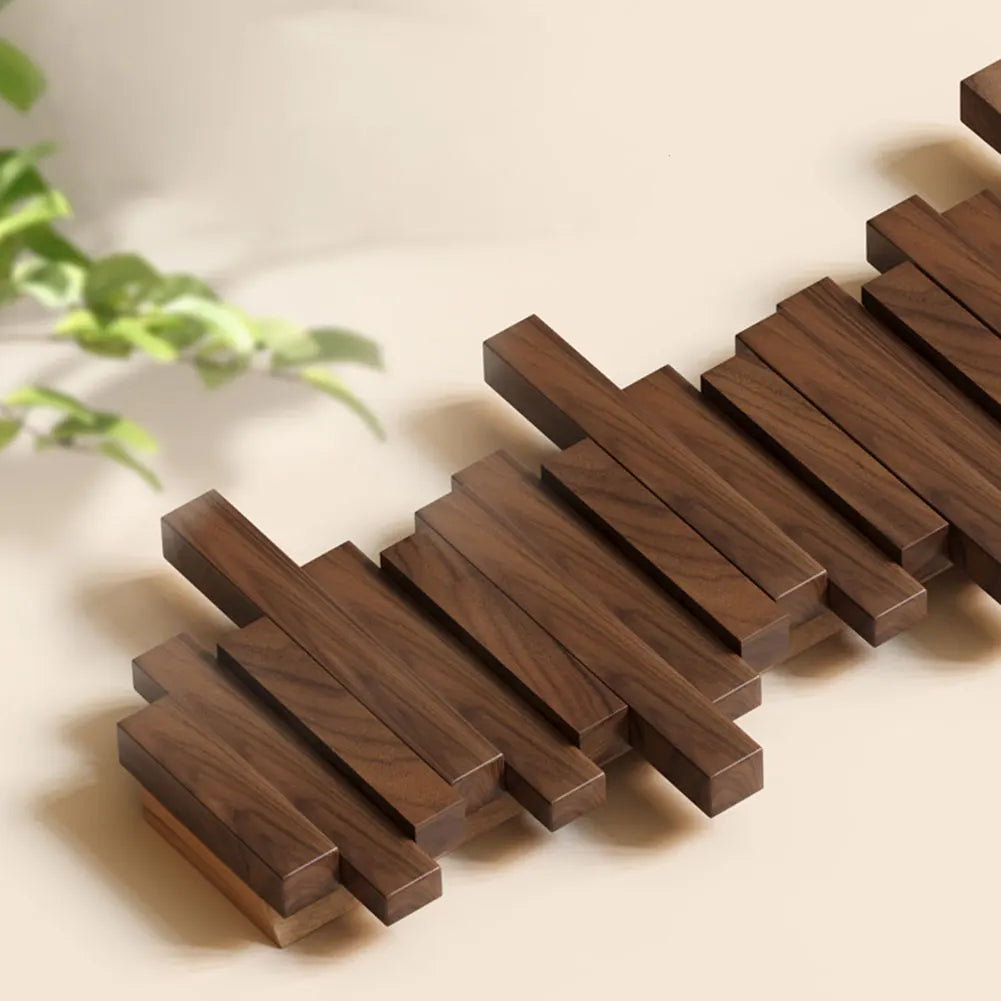 Space-saving folding wood coat rack. Wall-mounted natural wood hanger for modern entryway organization.
