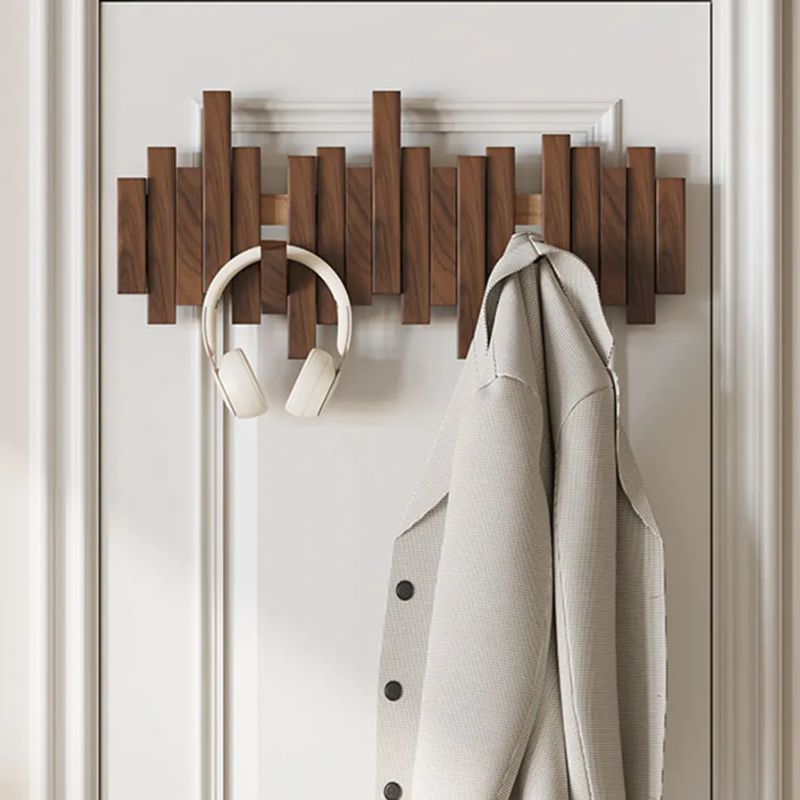 Modern natural wood space-saving coat rack. Wall-mounted folding design enhances home decor & entryways.