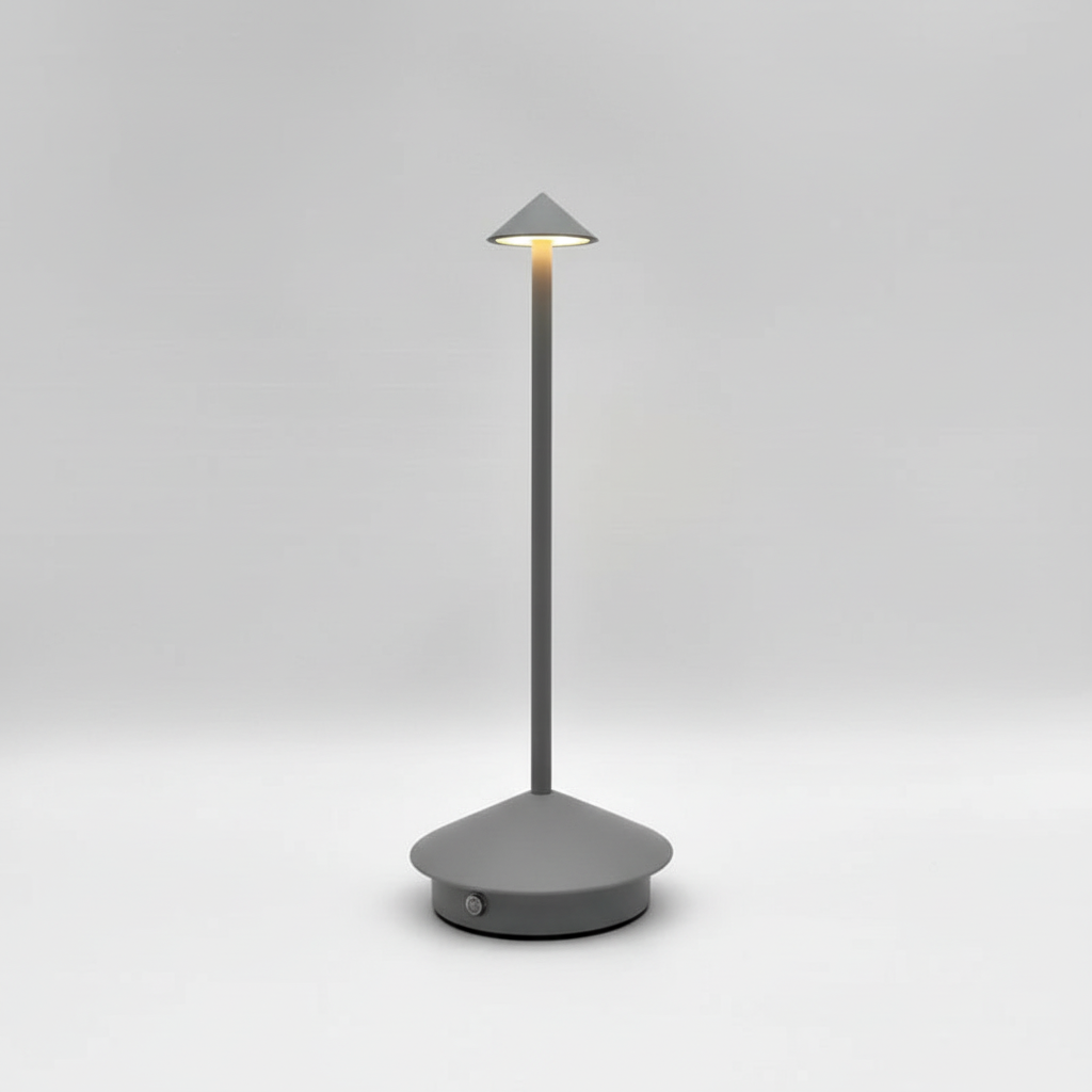 Compact rechargeable LED table lamp in sleek aluminum, delivering a warm, inviting glow for any space.