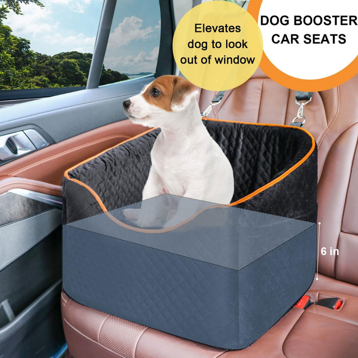 Small dog comfortably seated in a grey dog car booster seat with safety straps, elevated for road views.