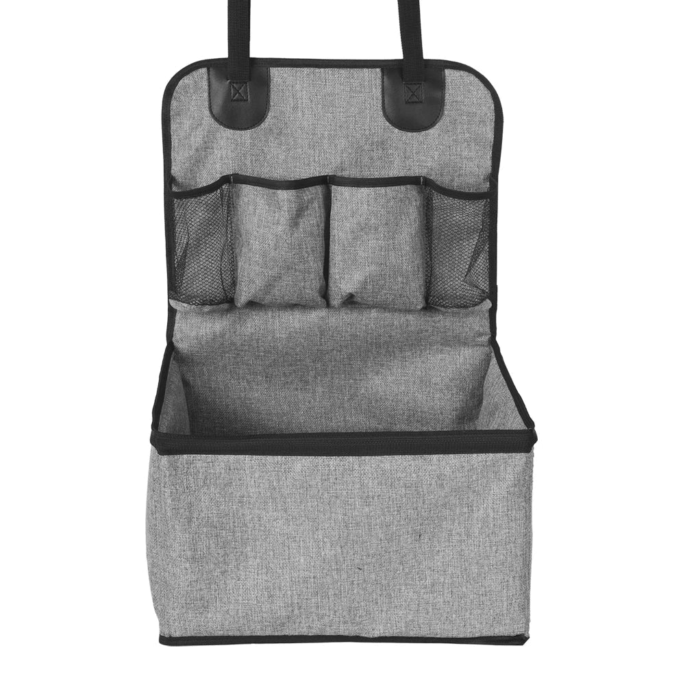 Small dog in elevated pet car seat with storage, featuring plaid interior, secured in vehicle