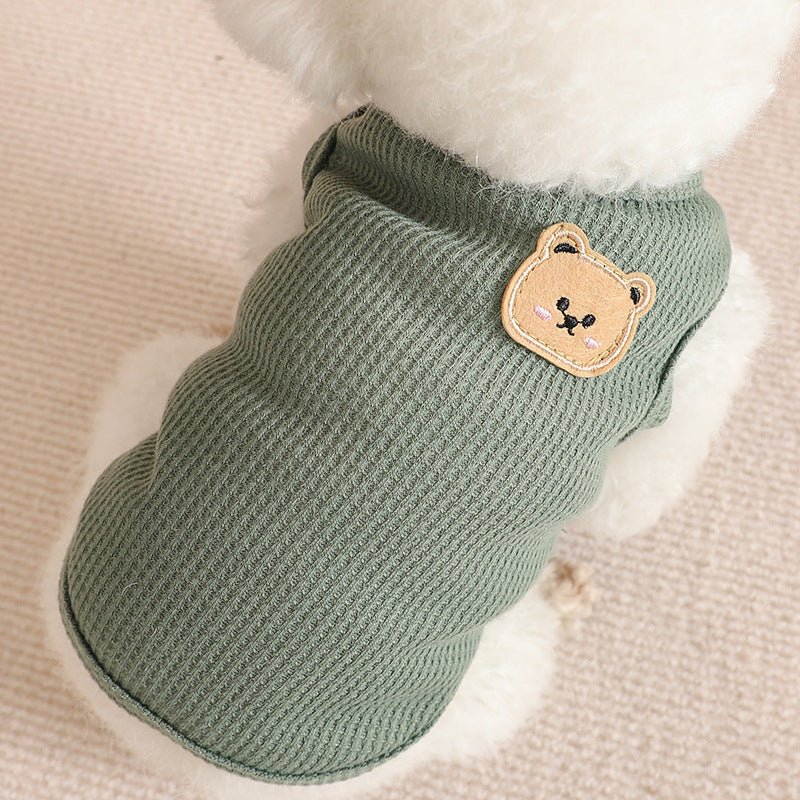 Small dog running outdoors in a durable, cozy waffle dog vest, suitable for active pets.