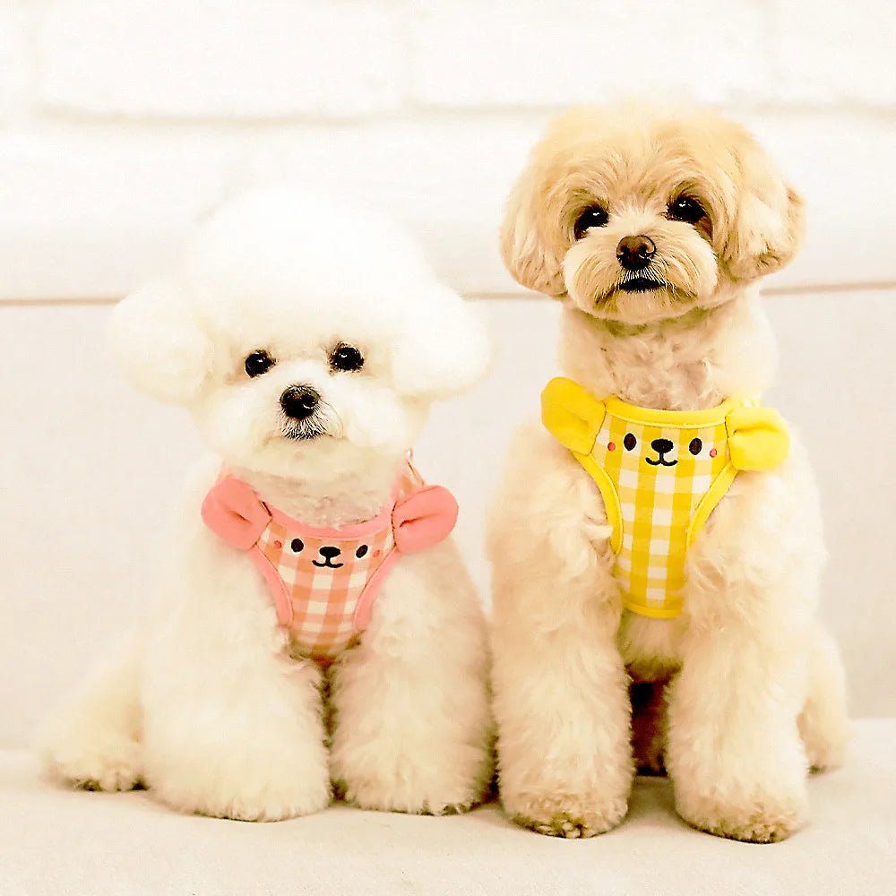 Happy dog wearing pink tank top harness, playing outdoors, perfect for small to medium dog walks.