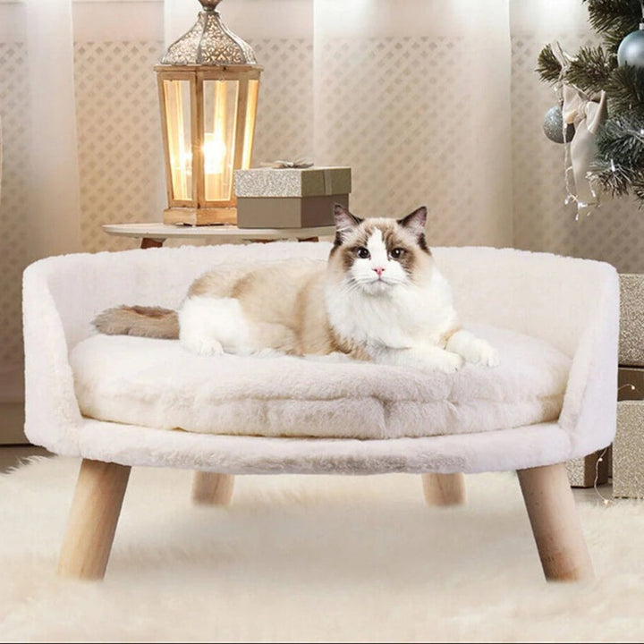 Round bolster pet bed for small dogs & cats, featuring soft plush fabric and stylish elevated wooden legs.