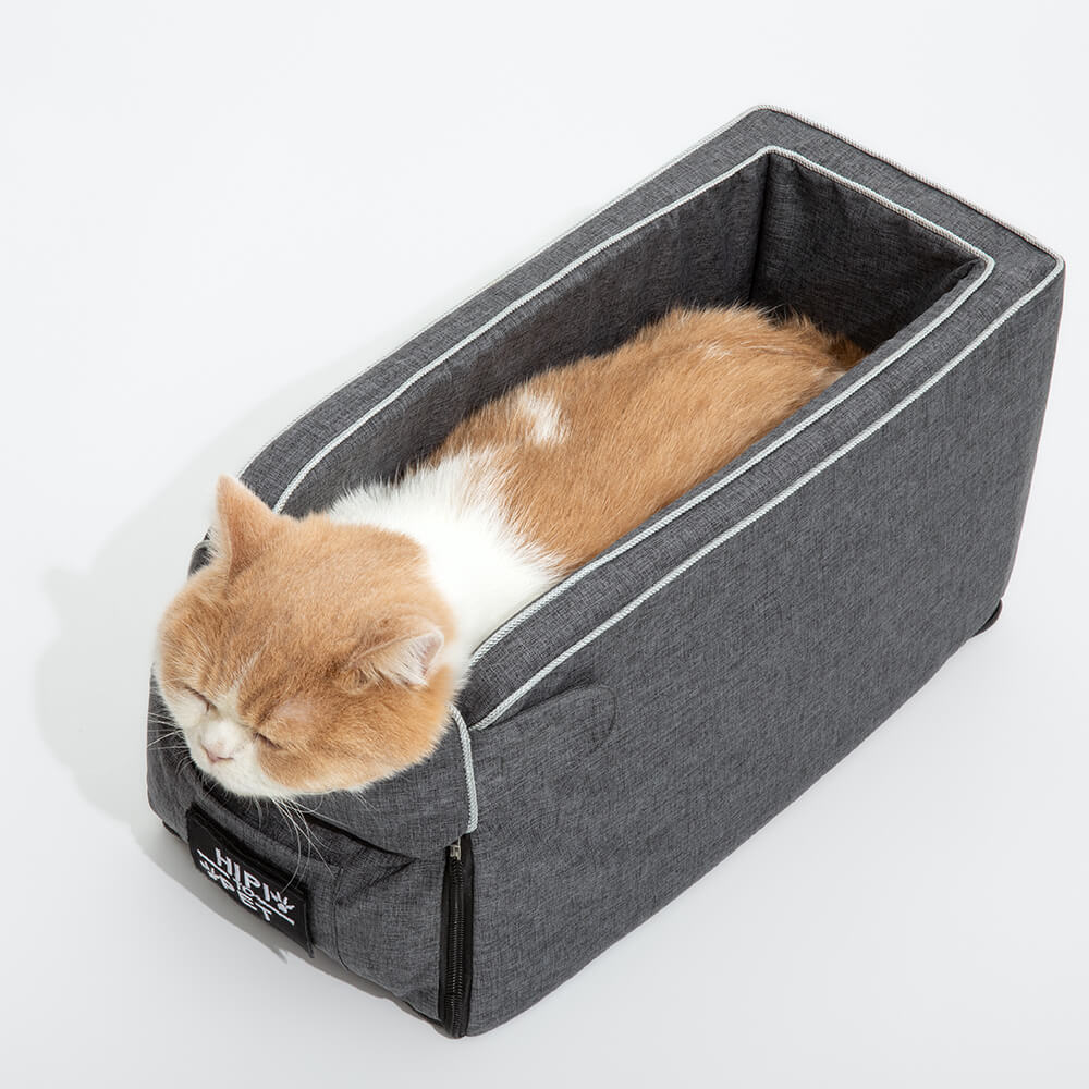 Empty grey suede dog car seat, emphasizing its washable design and console fit for small pets.