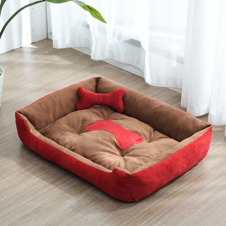 Cozy small pet calming bed featuring a supportive raised edge and an adorable bone-shaped pillow.
