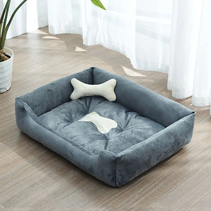 Compact small pet calming bed with a protective raised edge and charming bone pillow, ideal for small spaces.