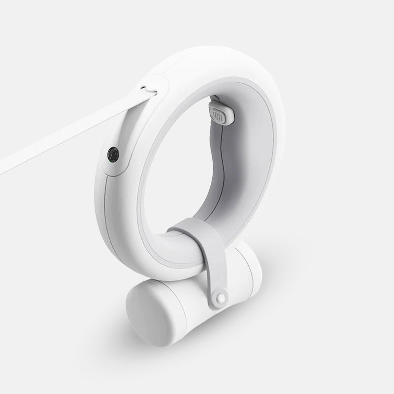 Close-up of the ergonomic handle of a smart retractable dog leash, emphasizing its quality design and integrated LED light.