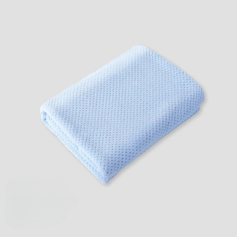 Soft coral fleece pet blanket in a cozy blue, perfect for dog and cat comfort.