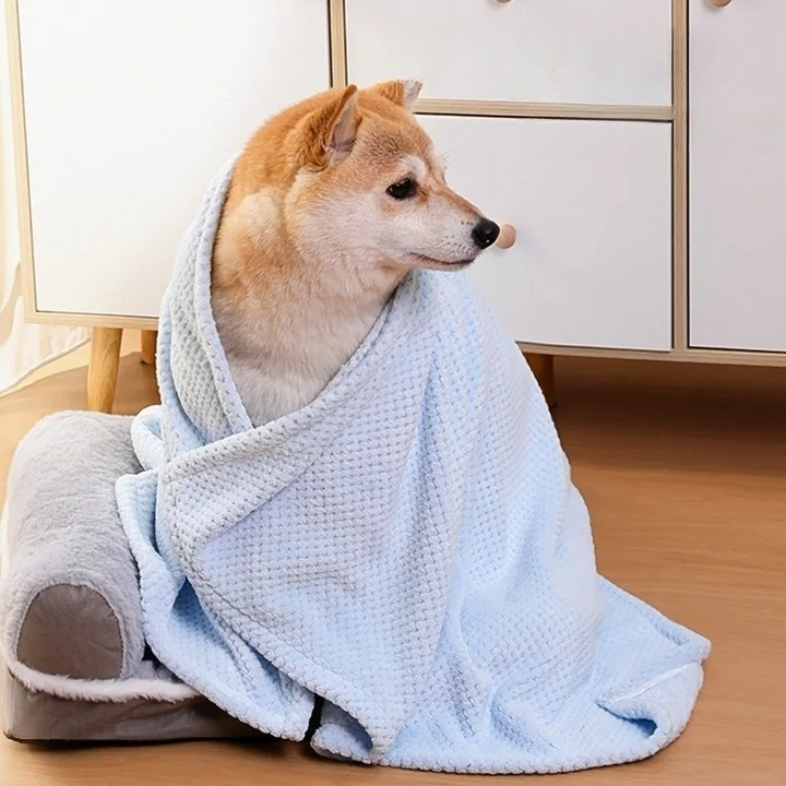 Folded pet fleece blanket in a vibrant pink, ideal as a washable dog bed accessory.