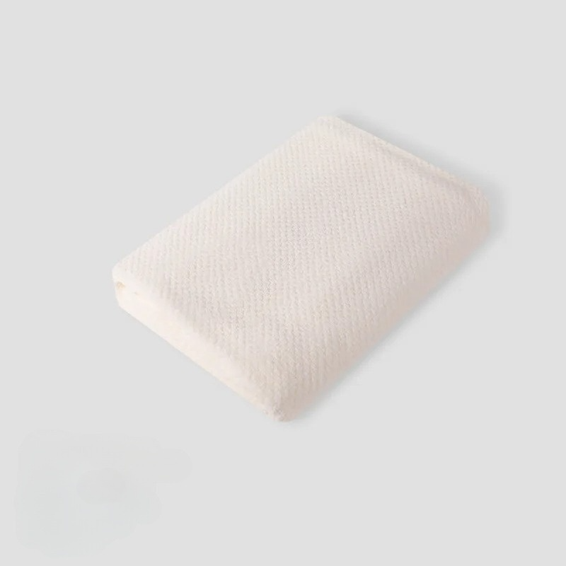 Close-up of a textured pet coral fleece blanket, showcasing its soft and breathable material.