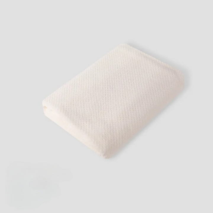 Close-up of a textured pet coral fleece blanket, showcasing its soft and breathable material.