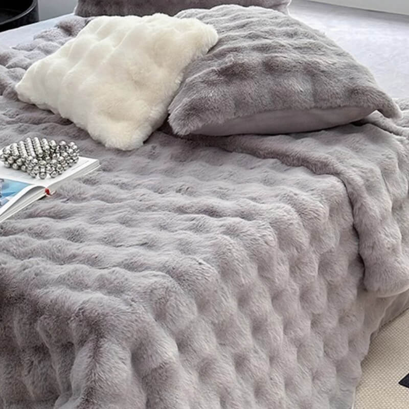 View of the elasticized edges on a non-slip faux rabbit fur fitted mattress cover, quality bedding.