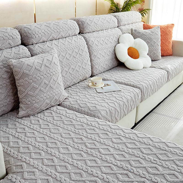 View of a living room with a sofa covered by a full wrap fleece stretch couch cover.