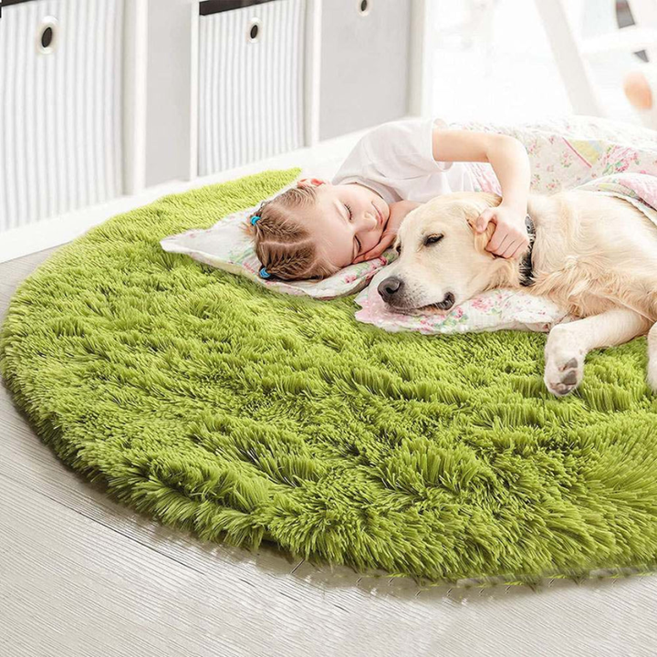 Pink plush faux fur round area rug, soft and fluffy for a nursery or child's room.