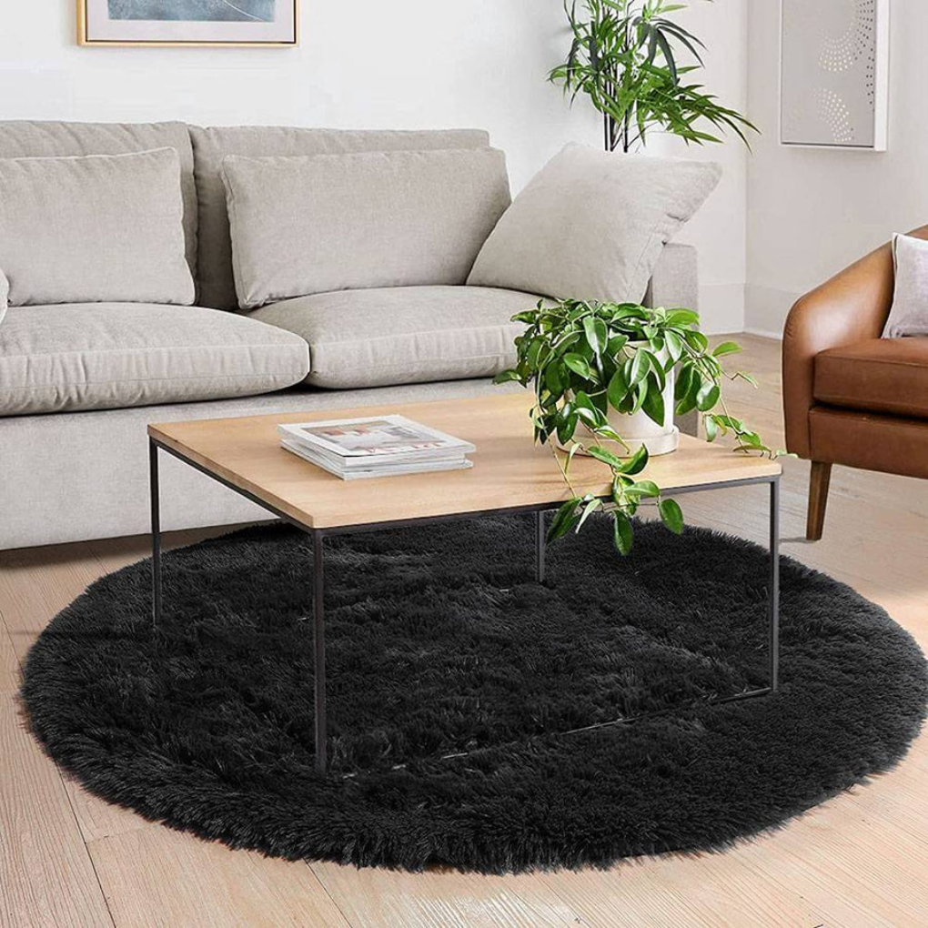 Unisex fluffy round rug in neutral beige, soft touch for bedroom or nursery area.