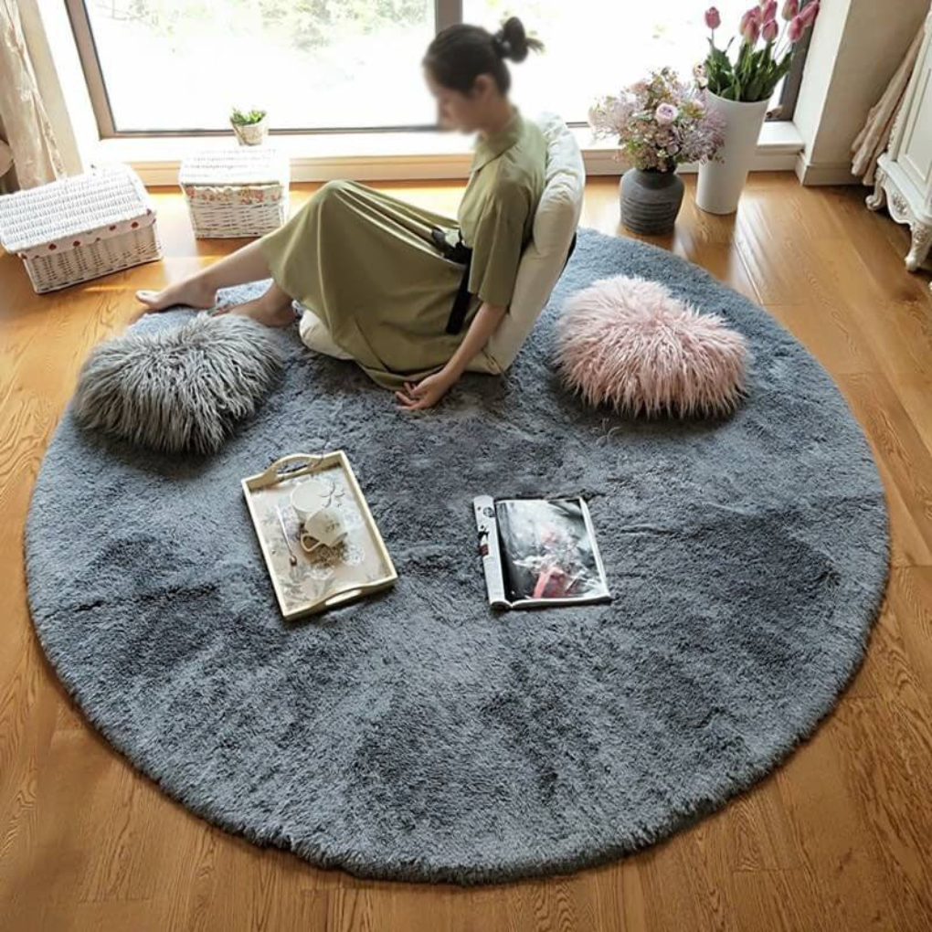 Zoomed shot of the thick, soft fibers of a circular faux fur rug, high-pile comfort.
