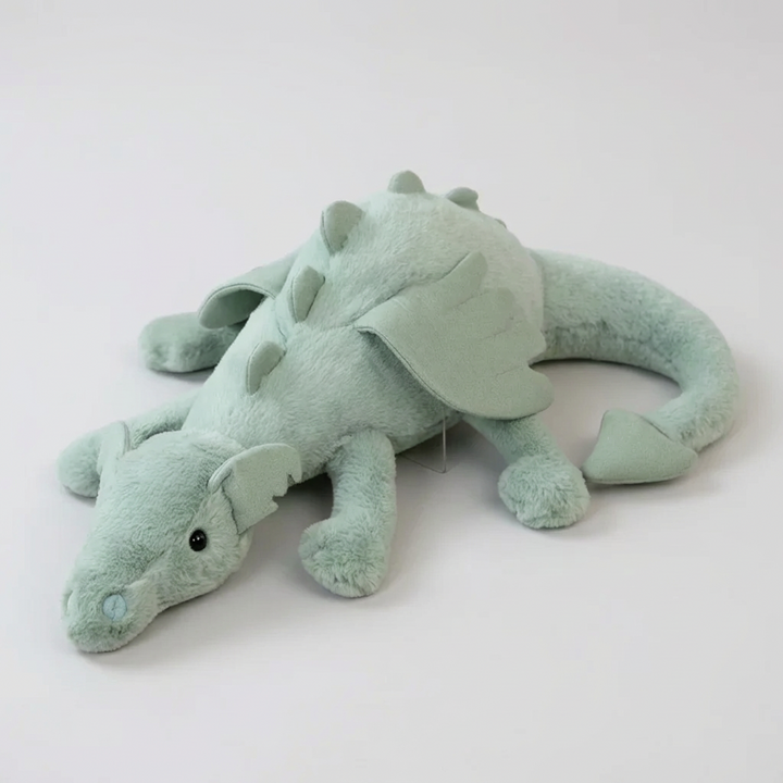 Soft green dragon plush toy with shiny wings, perfect for kids' imaginative play and cuddles. A magical stuffed animal.