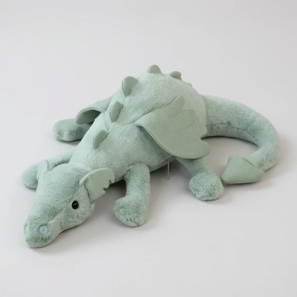 Soft green plush dragon toy with long tail, perfect cuddly adventure friend for children & nursery decor.