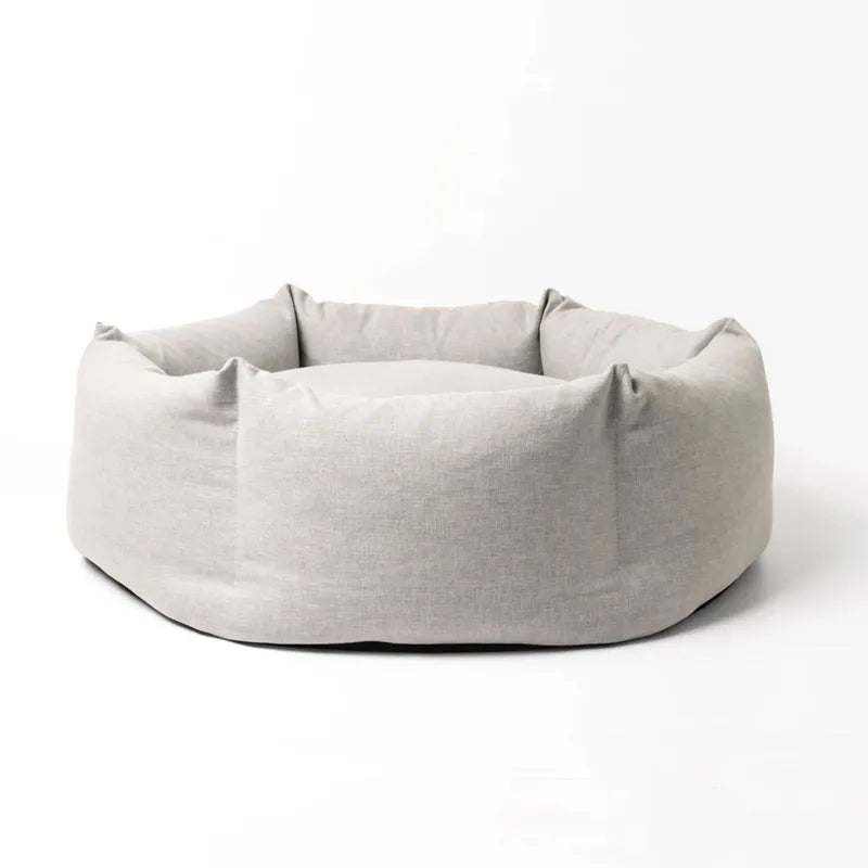 Washable pet bed with raised sides and plush interior, providing a cozy sleeping space for dogs.