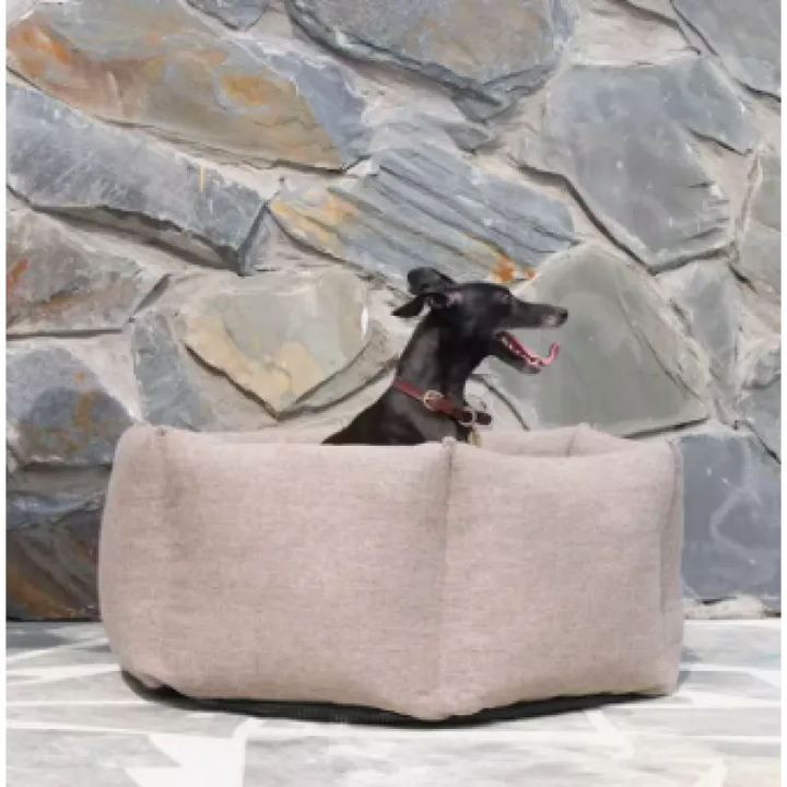 Beige high-sided dog bed, offering warmth and support for a restful sleep, a pet essential.