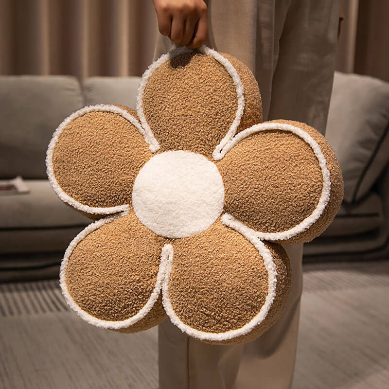 Soft plush flower throw pillow in a living room, cozy decorative accent