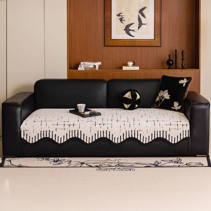 Thickened plush sofa protector with stylish wave edges, easy care home decor.