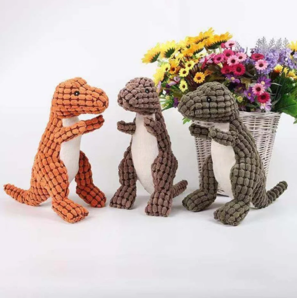 Cute kitten batting at a soft dinosaur pet toy, promoting active playtime for cats