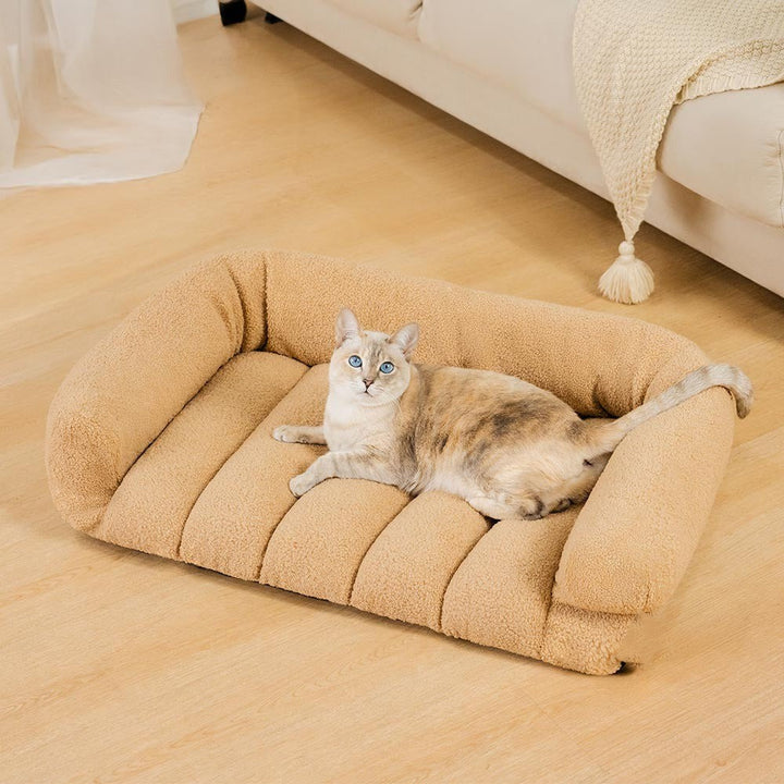 Washable orthopedic cat bed in soft plush fabric, offering a warm and supportive headrest