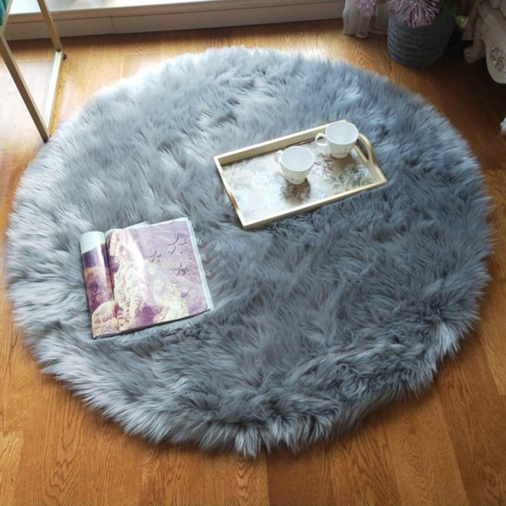 Round faux sheepskin rug in a minimalist setting, emphasizing its plush design