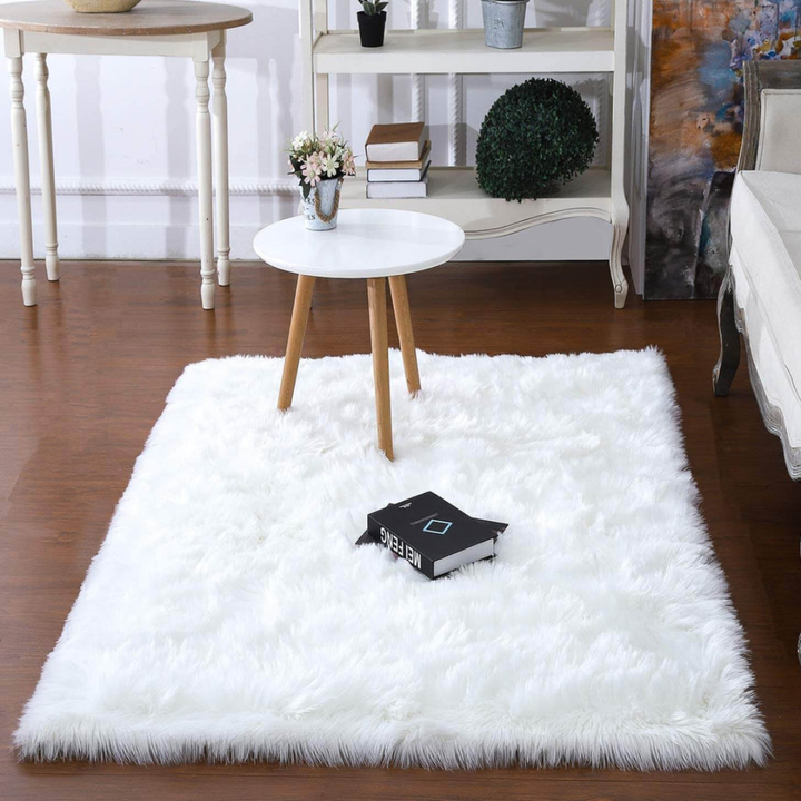 Luxurious faux fur sheepskin rectangular rug in ivory, ideal for bedroom or living room