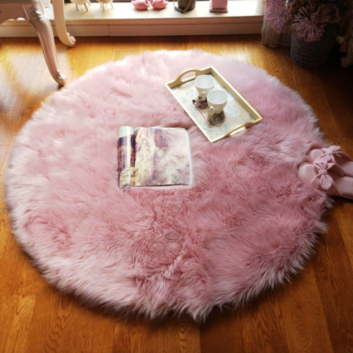 Plush cream-colored faux sheepskin rug, perfect for adding warmth to any room