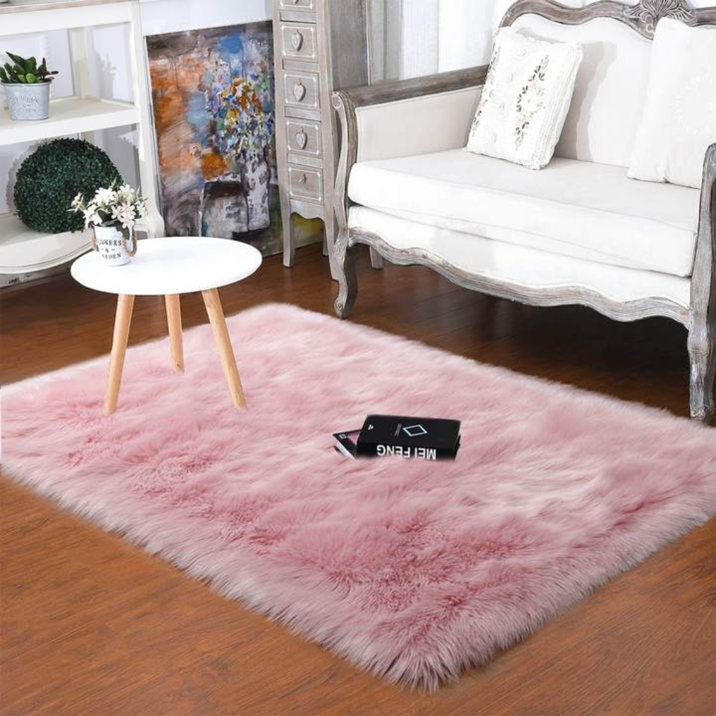 Bedroom featuring a round faux sheepskin rug next to a bed, enhancing decor