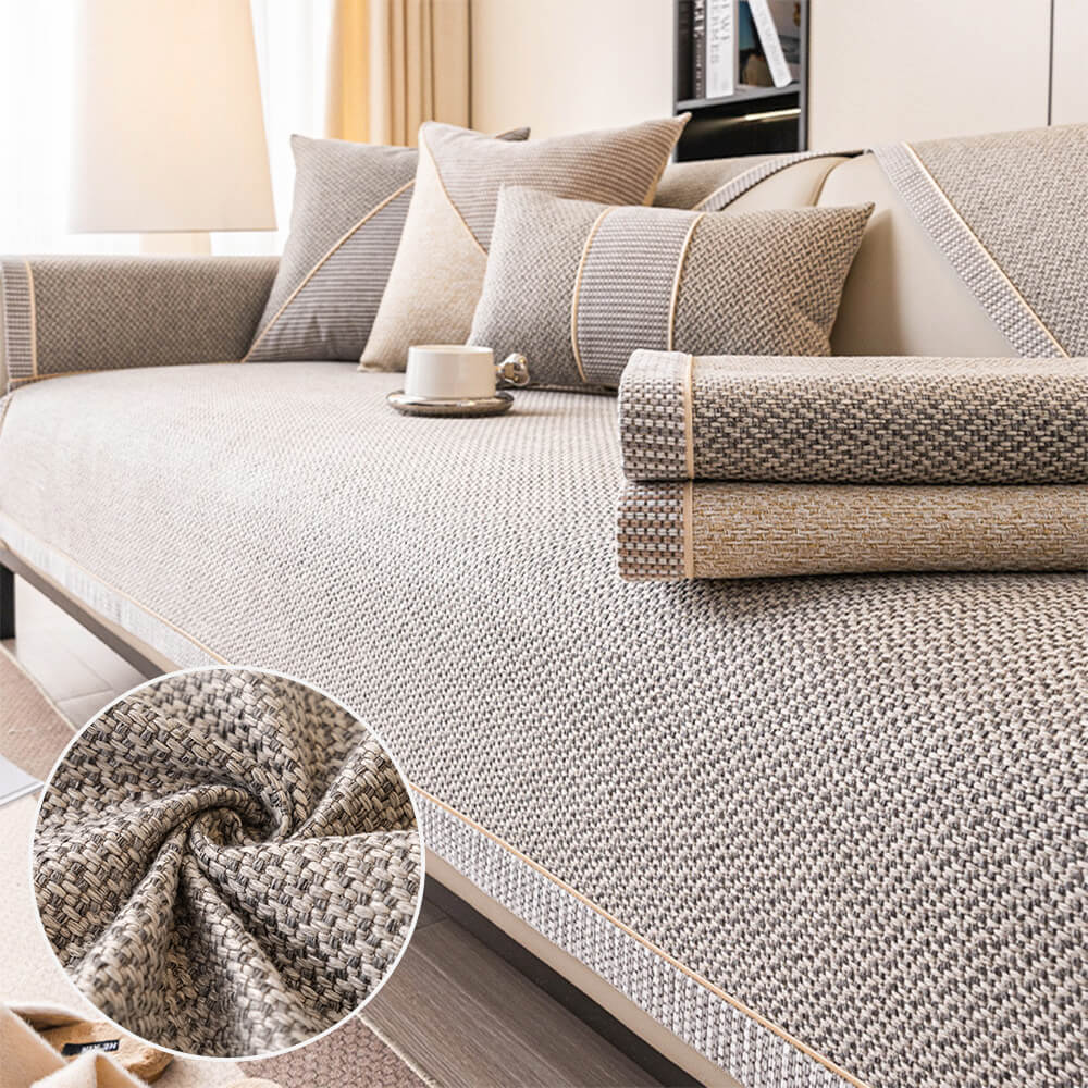 Light gray woven sofa cover with non-slip backing for living room furniture protection.