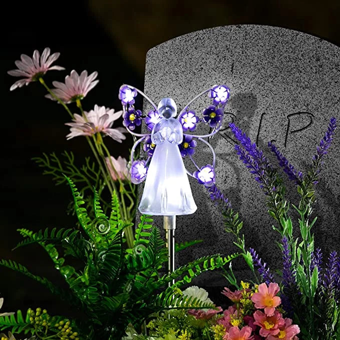 Closeup of weatherproof solar angel light with intricate wing details for garden and patio decoration.