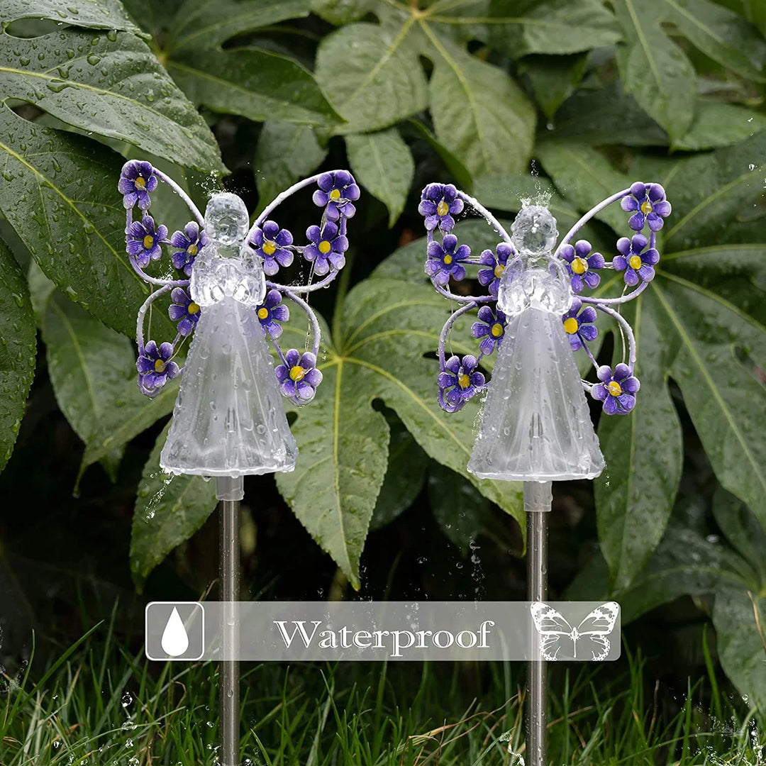 Solar powered angel stake emitting a warm light, suitable for year-round garden and yard embellishment.