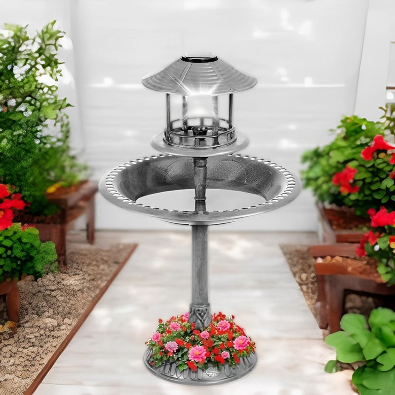 Outdoor garden decor: solar powered bird bath fountain with integrated planter and night glowing LED light.