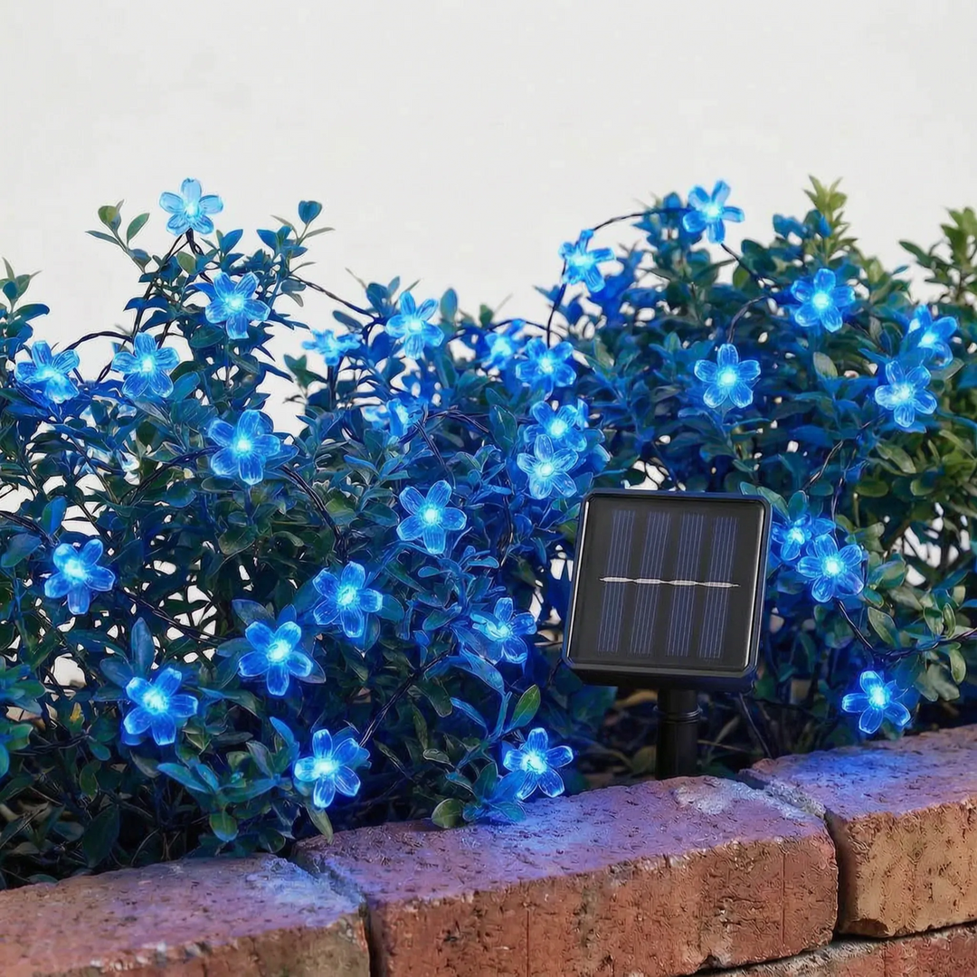 Vibrant solar LED blossom string lights glowing softly in a backyard, adding decorative ambiance.
