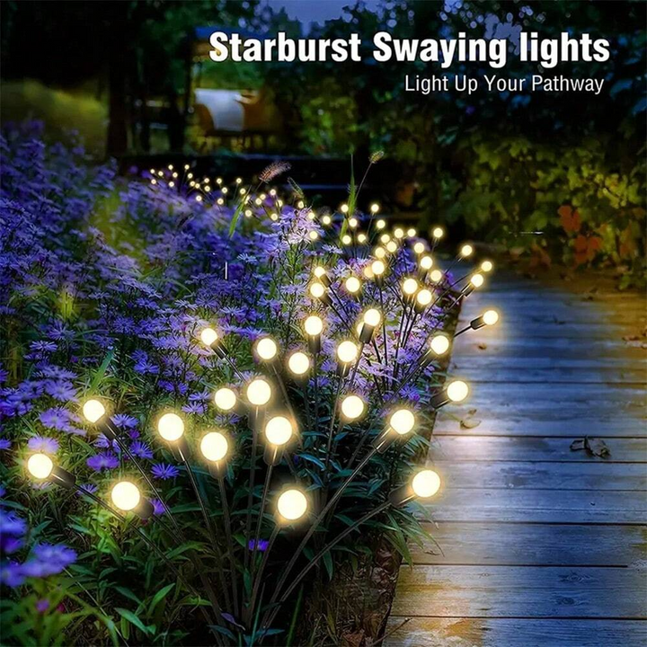Close-up of waterproof solar firefly lights with warm glow, ideal for garden and patio decor.