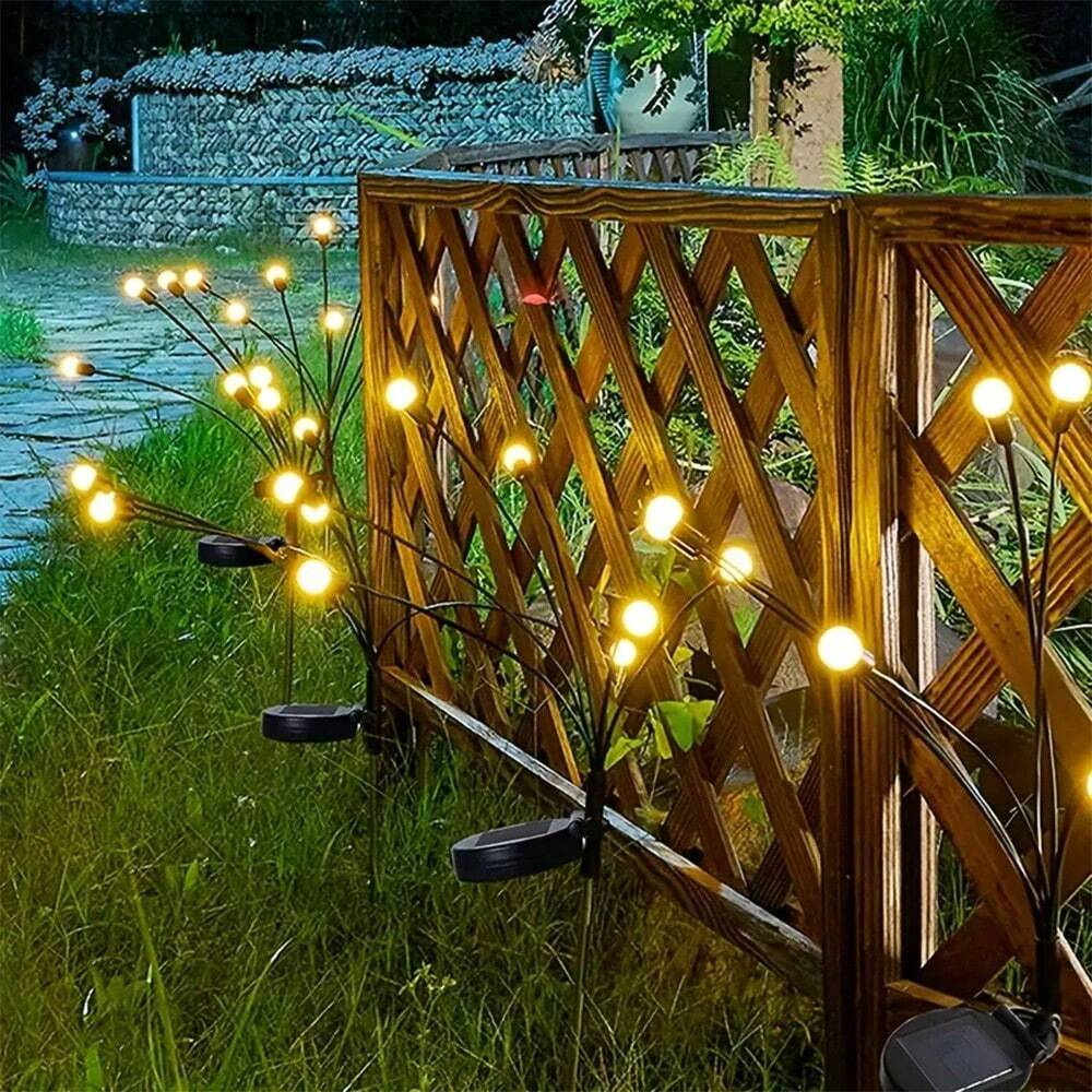 Group of solar firefly lights catching sunlight, ready to illuminate a garden or patio at night.