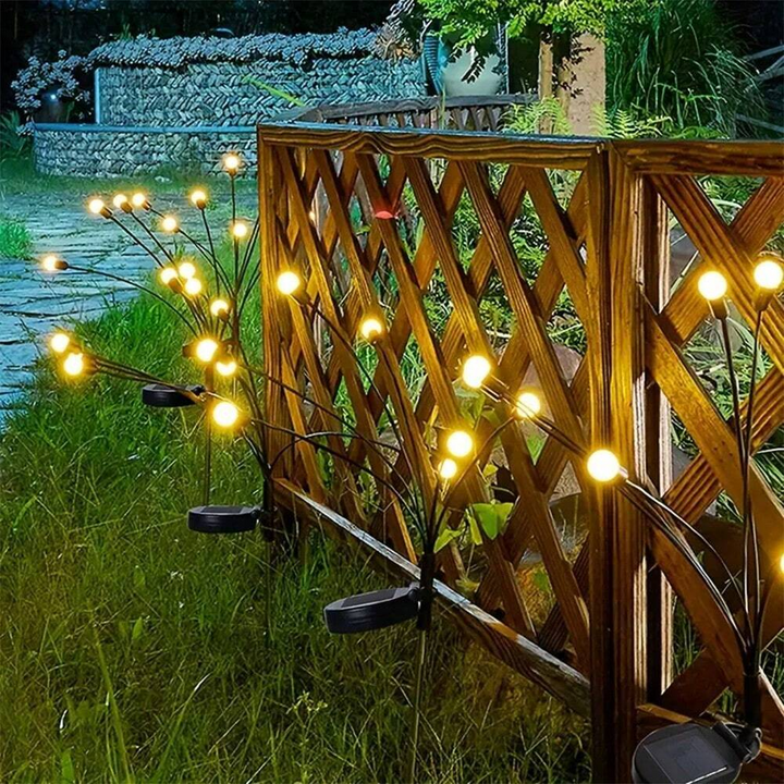 Group of solar firefly lights catching sunlight, ready to illuminate a garden or patio at night.